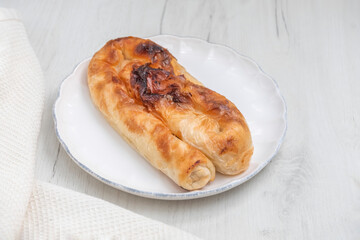 Savory Bulgarian cheese pastry Banitsa (Banitza) on white background