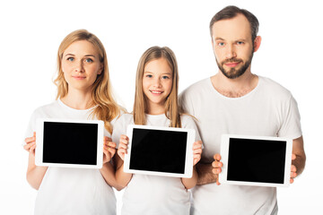 smiling family in white t-shirts holding digital tablets isolated on white