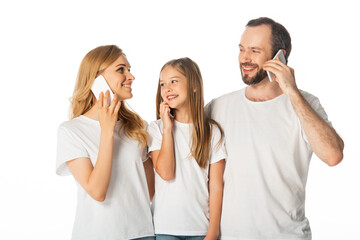 smiling family in white t-shirts talking on smartphones isolated on white