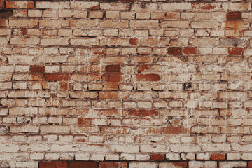 Old wall background with stained aged bricks. Grunge texture