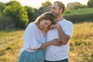 Happy and young pregnant couple in outdoors