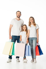 cheerful family with colorful shopping bags isolated on white
