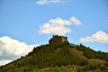 Fototapeta na wymiar Davalillo Castle on top of the mountain with cloudy blue sky.