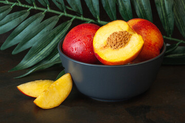 Peach or nectarine and peach slice with leaf on white background