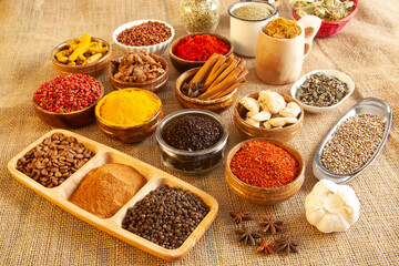 Various spices and herbs as a background.