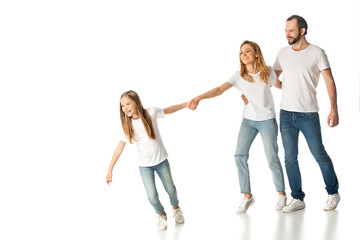 Obraz premium happy casual family holding hands while walking isolated on white