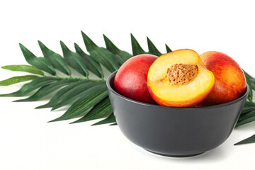 Peach or nectarine and peach slice with leaf on white background