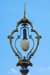 Fototapeta na wymiar Street lamp with wrought iron elements
