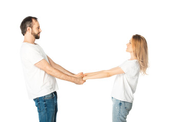 side view of adult couple in white t-shirts holding hands isolated on white