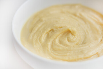 Swirls of Durian Paste on a White Table. Singapore Durian Mousse Dessert. Mao Shan Wang Durian Paste with Copy Space