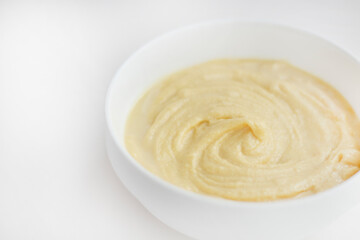 Swirls of Durian Paste on a White Table. Singapore Durian Mousse Dessert. Mao Shan Wang Durian Paste with Copy Space