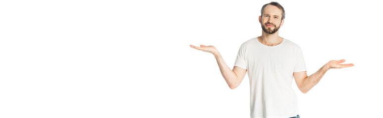 smiling man showing shrug gesture isolated on white, panoramic shot