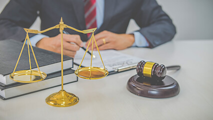 Judge gavel with Justice lawyers having team meeting at law firm background. Concepts of Law and...