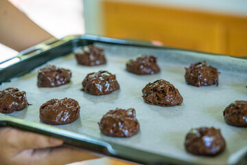 Closed up of brownie cookies on the baking plate preparing to bake. Food background, bakery and dessert.