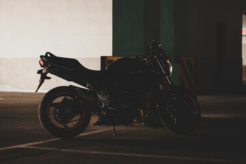 Black motorcycle on the background of underground parking.