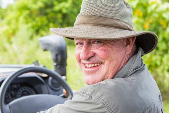 Portrait of smiling safari guide in a bush hat
