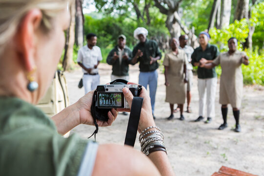 adult woman taking pictures of tented camp staff, Botswana