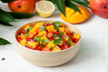 Fresh salad with mango, red pepper, tomatoes and cilantro. 