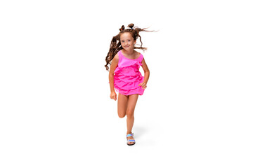 Happy child, little and emotional caucasian girl jumping and running isolated on white background. Looks happy, cheerful, sincere. Copyspace for ad. Childhood, education, happiness concept.