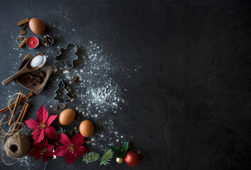 Christmas Baking Ingredients on Black Table, Christmas Flatlay on Dark Background with Copy Space. Christmas Cake Ingredients Top Down Shot