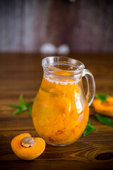 cold apricot compote in a glass decanter