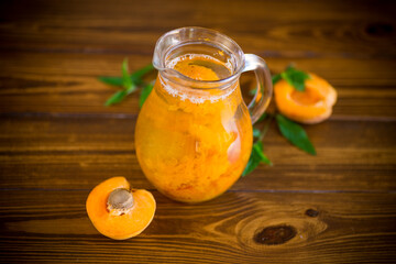 cold apricot compote in a glass decanter