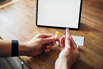 Home blood test kit with blank screen on a digital tablet