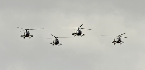 Fototapeta na wymiar Four military helicopters are flying in formation