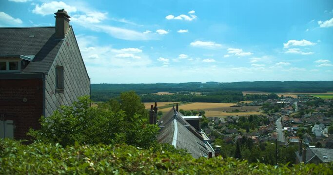 Idyllic village Laon in France seen from a hill on a sunny day, rural house, pan right