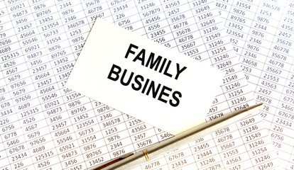 Obraz premium On the white business card is the inscription FAMILY BUSINES, against the background of the buchgalster account and pen.