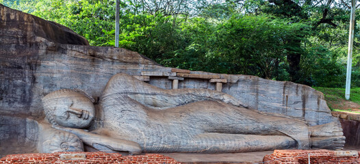 Buddha statue in Buddhist temple. Reclining Buddha at Polonnaruwa, Sri Lanka.