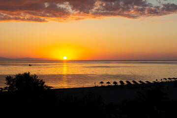Fototapeta na wymiar Magical sunrise over sea and beach in Greece