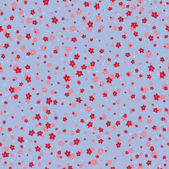 Vector seamless pattern with small pretty red and pink flowers on blue backdrop. Liberty style millefleurs. Simple floral background. Ditsy patterns. Elegant minimal ornament. Repeat design for decor
