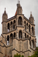 The tower building of the Cathedral of Notre Dame of Lausanne from distance. This isolated close up image shows details of the arched architecture of this medieval building