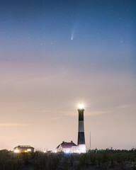 Naklejka na ściany i meble Comet Neowise over a tall stone lighthouse at dusk. Fire Island National Seashore - Long Island New York