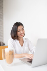 Asian business lady working in a random cafe