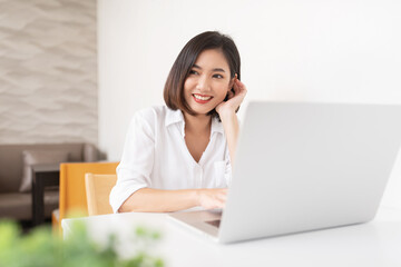 Beautiful Asian female model working in a cafe