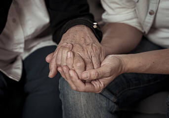 Fototapeta premium Close up of Senior mother and adult daughters hands holding each other