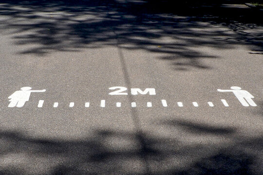 road markings that remind of social distance between people during the covid pandemic