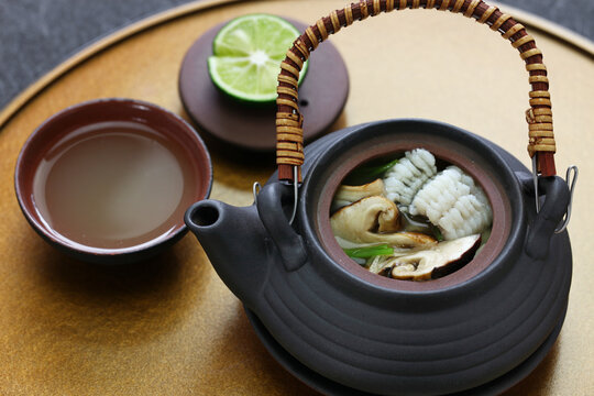 dobin mushi (Japanese cuisine) : steamed matsutake mushroom and pike conger with Japanese broth in an earthenware teapot and served.
