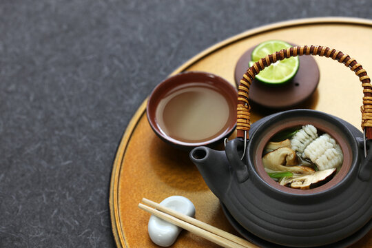 dobin mushi (Japanese cuisine) : steamed matsutake mushroom and pike conger with Japanese broth in an earthenware teapot and served.
