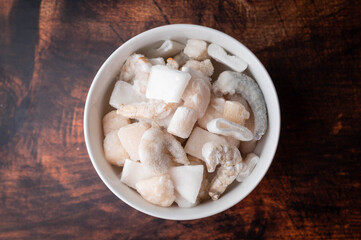 frozen seafood in white bowl