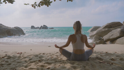 Woman Practising Yoga on the Beach