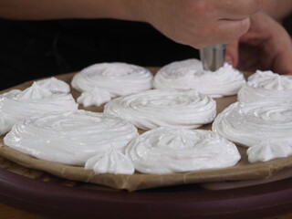 the cook makes meringue from cream.cooking cakes.