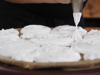 the cook makes meringue from cream.cooking cakes.
