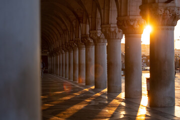 Morning Light Flares and Shadows Cascade Across Ancient Marble Pillars along the Grand Canal in...