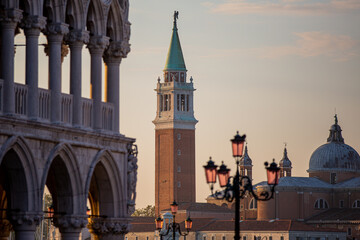 Fototapeta na wymiar Golden hour light covers San Marco Square in Venice Italy Along Grand Canal with San Giorgio Maggiore in the background