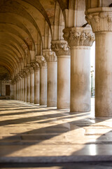 Fototapeta premium Morning Light and Shadows Cascade Across Ancient Marble Pillars along the Grand Canal in Venice Italy