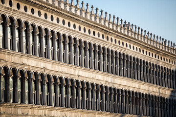 Naklejka premium Breathtaking Architecture of Column Arches Line the Interior of Saint Mark's Square in Famous Venice Italy 01