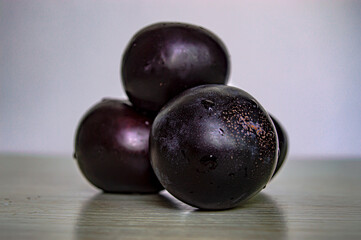 purple ripe plum close up on white fruit background
